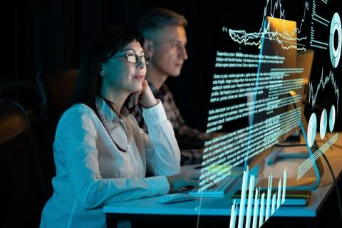Woman Analyzing Data on Computer Screen in Modern Office Stock Photos