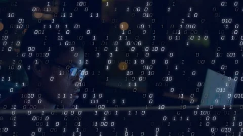 Woman analyzing data at night desk, monitor output starting streaming binary Stock Footage 332881859