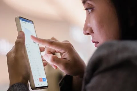 Woman analyzing data on smartphone screen Stock Photos