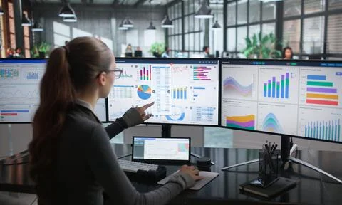 Woman Analyzing Financial Data On Computer To Improve Business Strategy. Stock Photos