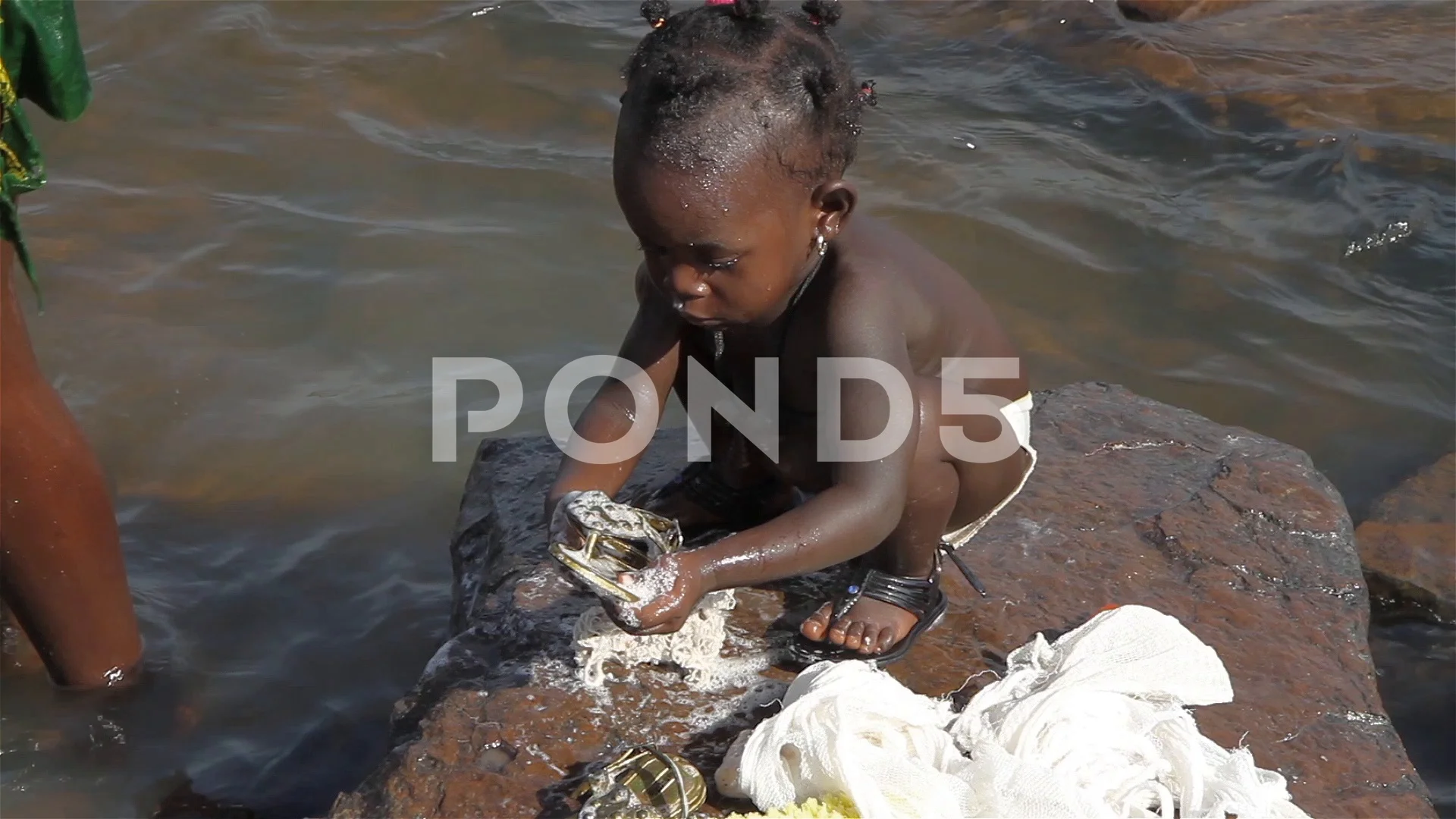 woman and baby taking bath in river - Gu, Stock Video