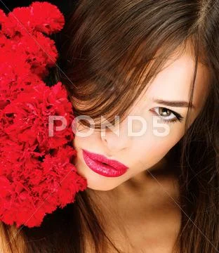 Woman and bouquet of red carnations Stock Photos