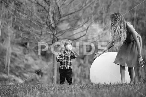 Woman and boy with bog ball Stock Photos