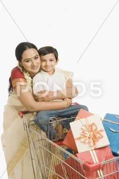 Woman and her son with a shopping cart Stock Photos