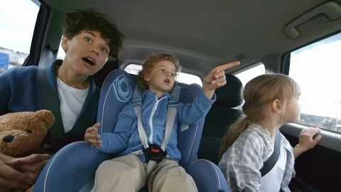Woman and Kids Riding in Backseat of Moving Car Stock Footage