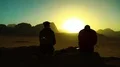 Woman and man looks at sun in Wadi Rum desert, Jordan HD Footage