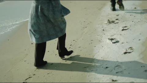 A woman and a man in a raincoat and high-heeled boots Stock Footage 241311953