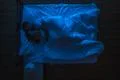 The woman and man sleeping on the bed. Evening night time. View from above Photo