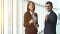 The woman and a man talk and gesture in the office hall. slow motion 4k or 4k+ Resolution