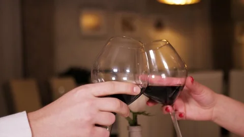 Woman and man, toast, clinking with wine glasses in a restaurant in the evening Stock Footage