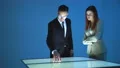 The woman and a man working with a virtual screen 4k or 4k+ Resolution