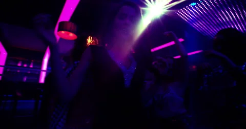Woman and party friends enjoying music and dancing in nightclub Stock Footage