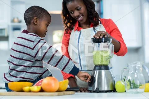 Woman And Son Using Mixer