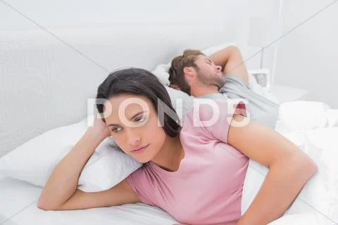 Woman annoyed that her partner is sleeping Stock Photos