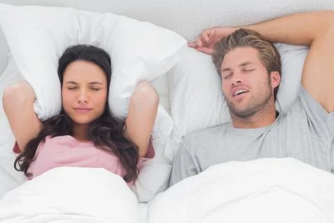 Woman annoyed by the snoring of her partner Stock Photos