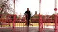 Woman answers her phone as she walks alone HD Footage