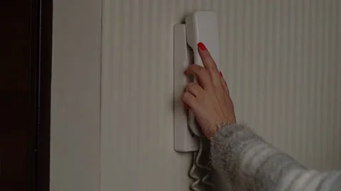 Woman answers the intercom call, opens the door Stock Footage 130855291