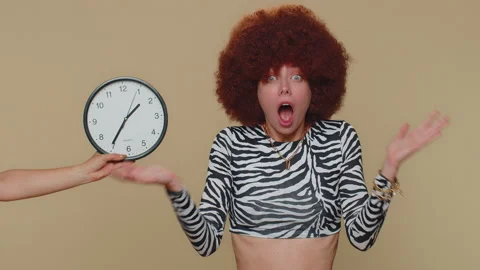 Woman with anxiety checking time on clock, running late to work, being in delay Stock Footage 202315422