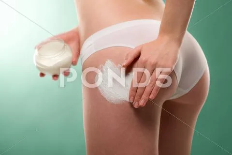 Woman apply cellulite cream on bottom Stock Photos