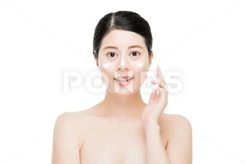 Woman applying cream on the cheek and nose Stock Photos