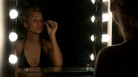 Woman   applying make up Stock Footage 704059