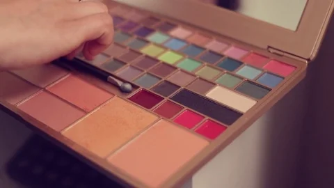 Woman applying make up Stock Footage 75219229