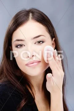 Woman applying make up Stock Photos