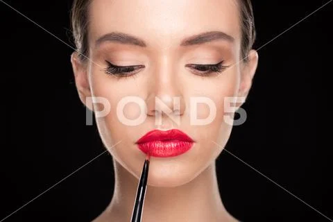 Woman applying makeup Stock Photos