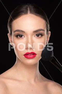 Woman applying makeup Stock Photos