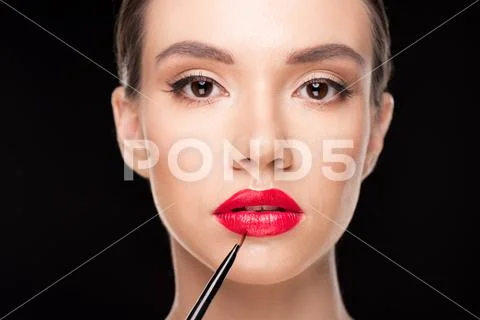 Woman applying makeup Stock Photos