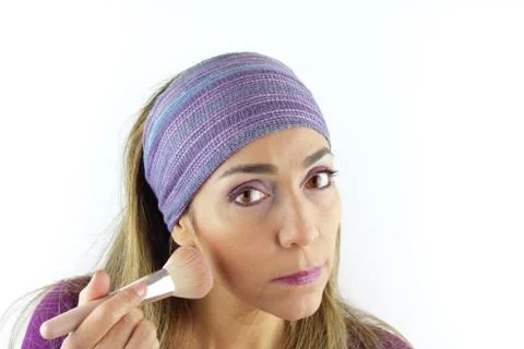 Woman applying makeup Stock Photos