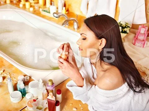 Woman applying moisturizer. Stock Photos