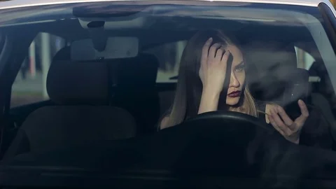 Woman applying powder in the car Stock Footage