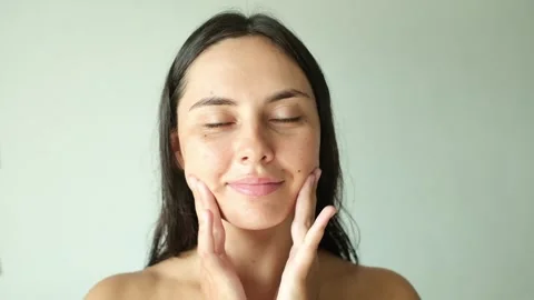 Woman Applying Serum with Both Hands for Healthy Skin Stock Footage 339718533