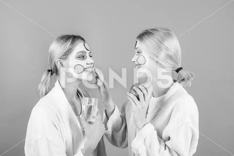 Woman applying skin cream. Portrait Of two Beautiful Young Female Models With Stock Photos