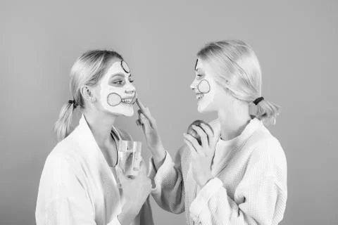 Woman applying skin cream. Portrait Of two Beautiful Young Female Models With Stock Photos