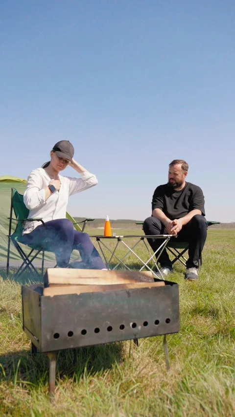 Woman applying sunscreen while camping with man Stock Footage 344603491