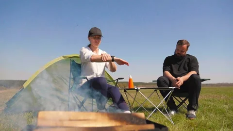 Woman applying sunscreen while camping with man Stock-Footage 344608454