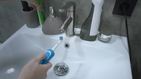 Woman applying toothpaste to toothbrush, Stock Footage 302541503