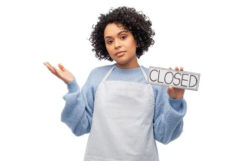 Woman in apron holding closed sign Stock Photos