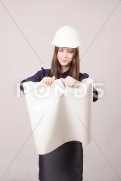 Woman architect in helmet drawing tears Stock Photos