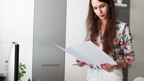 A woman, architect, interior designer is reading the maps, planns Stock Footage 157304517