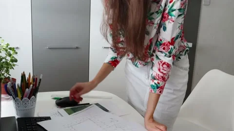 A woman, architect, interior designer is reading the plans, maps Stock Footage 157304525