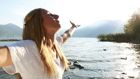 Woman arms outstretched at sunset Stock Footage