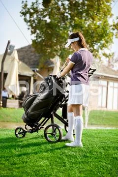 Woman arranging your golf equipment Stock Photos