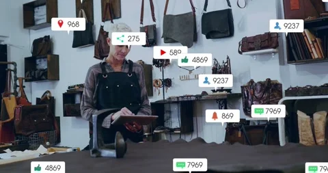 Woman artisan tapping tablet spawning floating badges over leather hide and Stock Footage 334038928