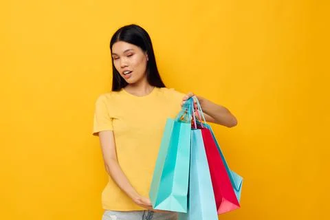 Woman with Asian appearance fashion shopping posing isolated background Stock Photos