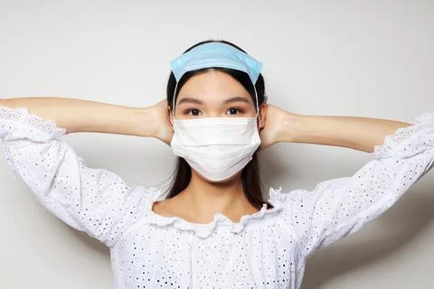 Woman with Asian appearance medical mask protection isolated background Stock Photos