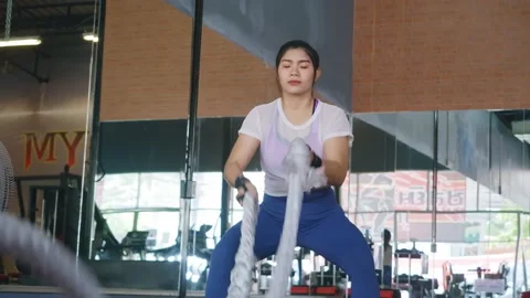 Woman Asian In A Gym Exercises With Battle Ropes Stock Footage