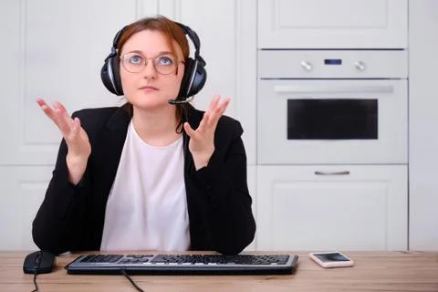 A woman asks for help from above while working online. Problems with Internet Stock Photos
